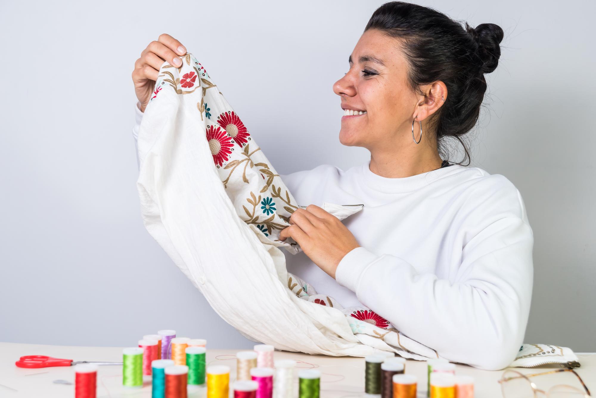 artisan at work stitching a floral pattern