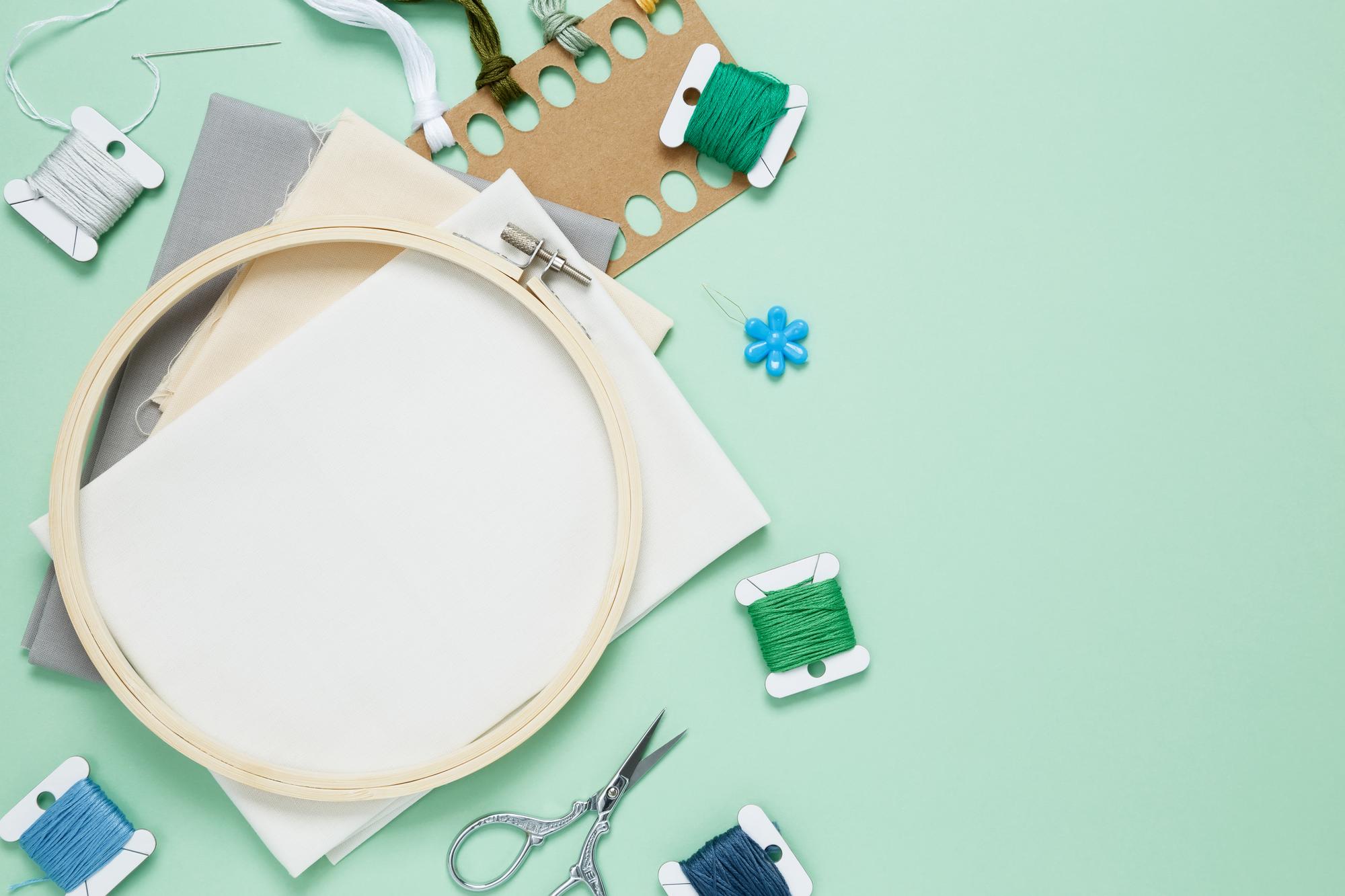 flat lay of three embroidery kits and tools